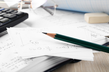 School supplies and textbook on mathematics close up