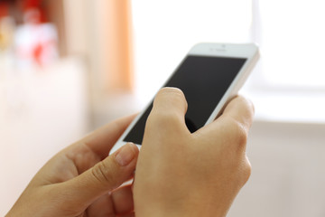 Woman holding smartphone indoors
