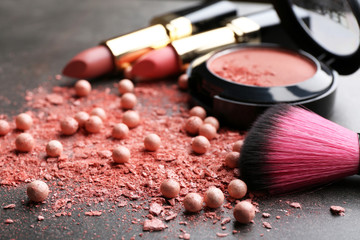 Decorative cosmetics and accessories for makeup on grey background