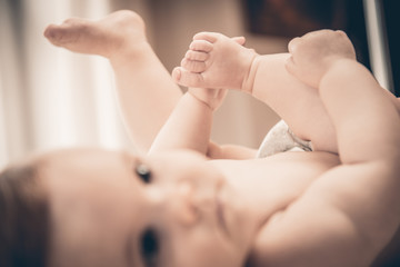 Baby holds his small hands their feet close-up