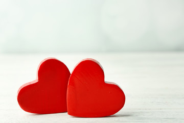 Fototapeta premium Wooden hearts on light background