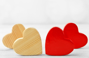 Wooden hearts on light background