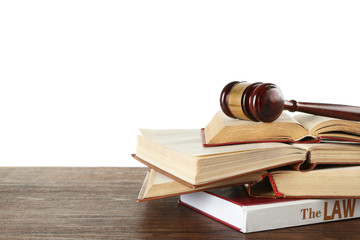 Gavel and books on wooden table on white background