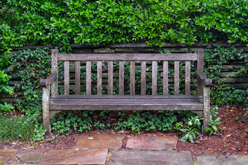 Aged Wooden Park Bench on Flag Stone