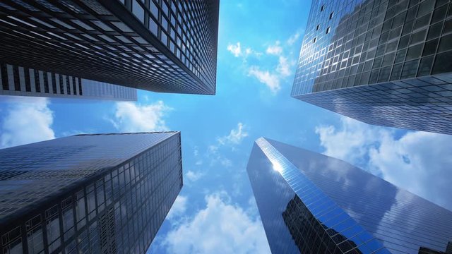 Blue sky and clouds reflecting over skyscrapers facades in Financial District in New York City, time lapse