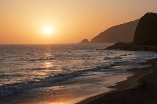 The Pacific ocean during sunset. Landscape with blue sea, the mountains and the dusk sky, the USA, Santa Monica. 