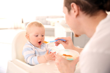 Father feeding his baby son