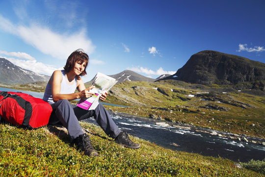 Woman reading map in mountains