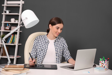 Woman using graphic tablet at office