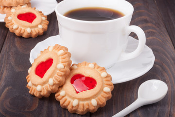 cookie with heart  jelly cup of coffee on  wooden table