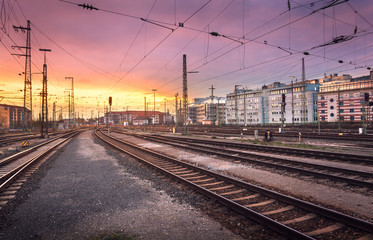 Industrial landscape. Railway Station in Nuremberg, Germany. Railroad at colorful sunset on the background of beautiful sky and city buildings.