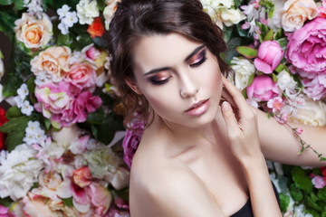 Portrait of beautiful fashion girl, sweet, sensual. Beautiful makeup and messy romantic hairstyle. Flowers background.