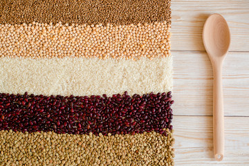 Grain and beans on white wooden background. top view