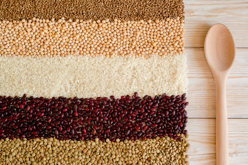 Grain and beans on white wooden background. top view