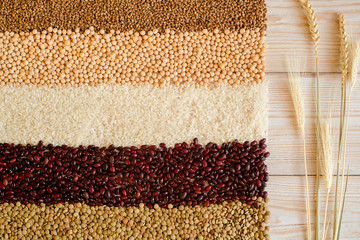Grain and beans on white wooden background. top view