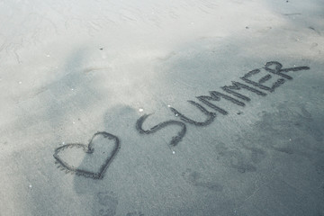 The word heart summer written on beach