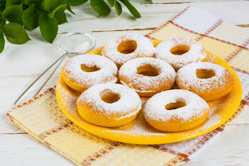 Delicious donuts on yellow plate