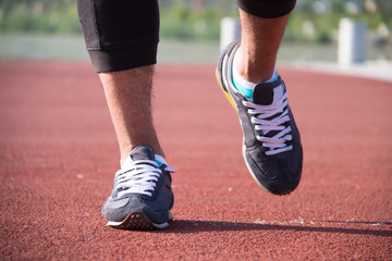 Fototapeta na wymiar Closeup of a runner feet running on the road