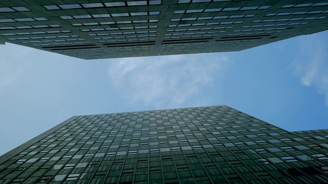 Blue sky and towering skyscrapers in Lower Manhattan, New York City, panning