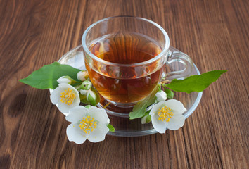 Tea in a glass cup with jasmine flowers
