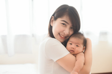 Fototapeta na wymiar Happy mother holding adorable child baby boy