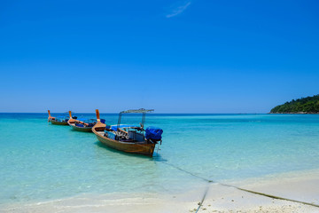 Fototapeta premium fishing boat against clear sea and blue sky