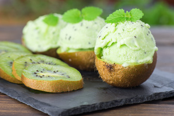 Kiwi sorbet balls inside of its skin