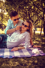Sweat couple relaxing in summer park.