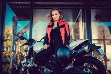 Plakat Blond female posing near motorcycle.