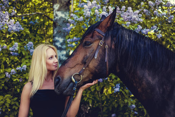 Obraz premium Portrait of blond female with horse.