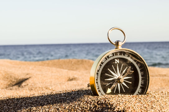 Compass on the Sand Beach