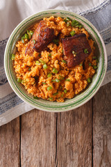 spicy bulgur with beef close-up on a plate on the table. vertical top view
