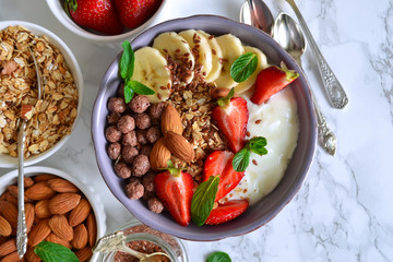 smoothie in a bowl for breakfast with yogurt, strawberries, oatm