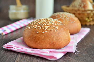 homemade buns with sesame seeds and milk for breakfast