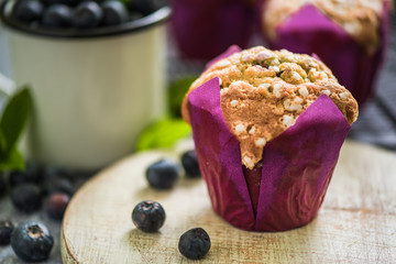 blueberry muffin on wooden board