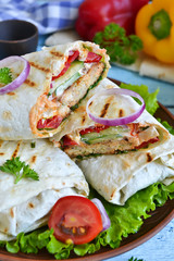 shawarma Lavash with chicken, tomatoes, lettuce and peppers on a