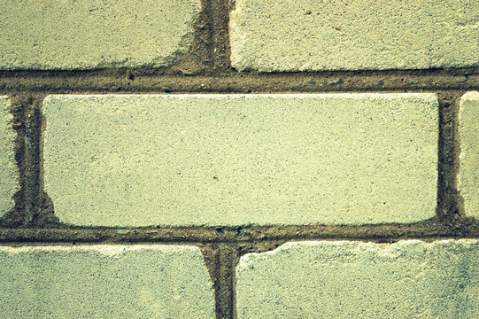 One imbedded white brick in the wall