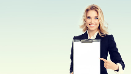 Fototapeta premium young businesswoman showing blank clipboard