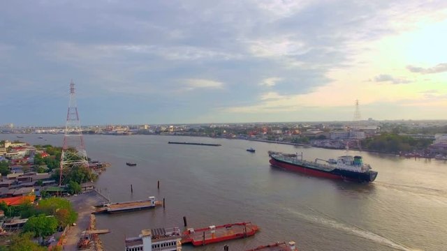 aerial top view of container transportation ship on chao phraya river at twilight or evening time, transportation concept, tracking camera shot, High quality footage 4K