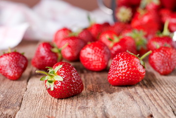 ripe strawberries scattered on the table