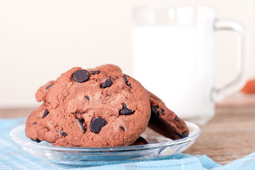 chocolate chip cookies and a glass of milk on the table