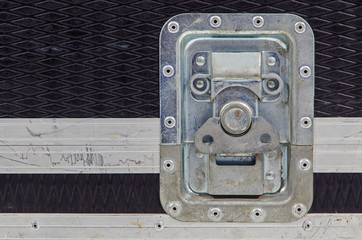 close-up of a metallic lock on a case for transportation of music equipment