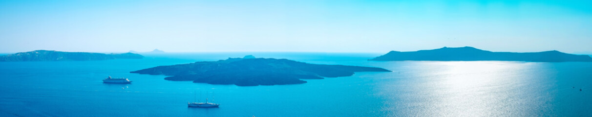 Panoramic bird eye aerial view of white building, blue sky and vivid sea in Santorini island, Oia, Greece