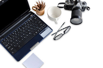 office desktop with notebook pencil blank note and old camera