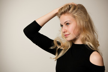 Beautiful young woman with gorgeous hairstyle posing  over white