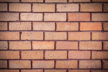 Orange brick wall. brick texture. brick pattern. Part of brick wall for background and design with copy space for text or image. Dark edged.