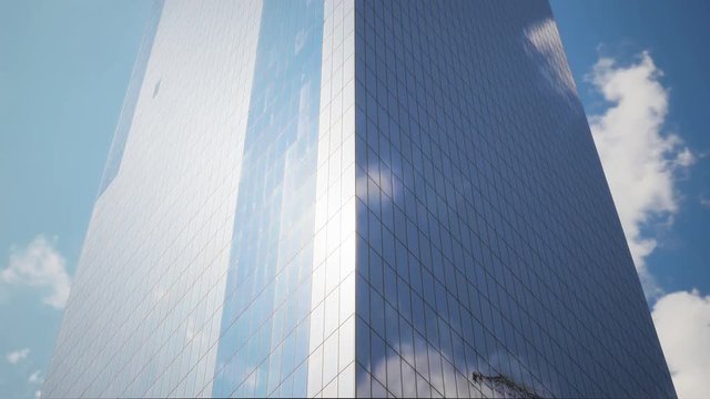 Blue sky and clouds reflecting over skyscraper mirror facade on Manhattan New York City detail