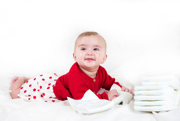 Naklejka premium The child in bright clothes and diapers on a white background