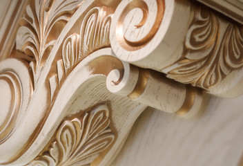 abstract background. carving element. furniture in classic style. white tree with gold trim. patina. carving. small depth of field. luxury furniture.