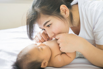 Happy mother holding adorable child baby boy